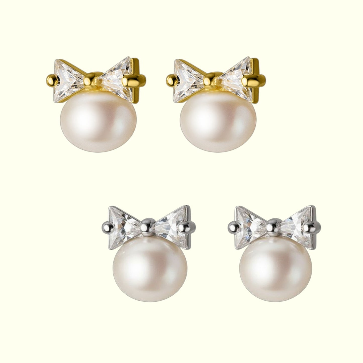 Pair of pearl earrings with bow and crystal details on a white background