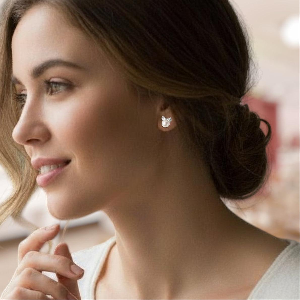 Woman wearing a diamond earring with a blurred background