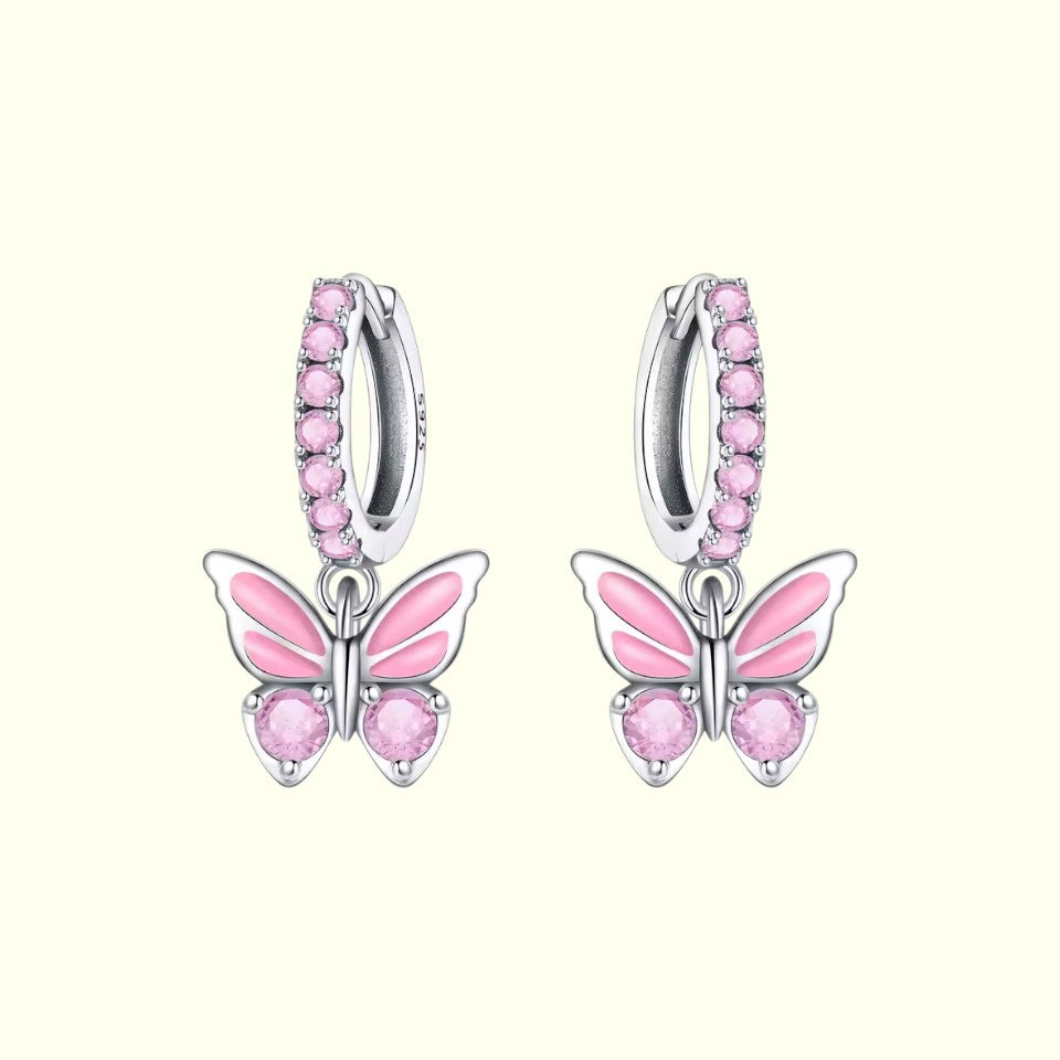 Pink butterfly earrings with silver accents on a white background