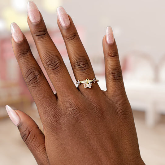 Hand wearing a gold ring with a blurred background