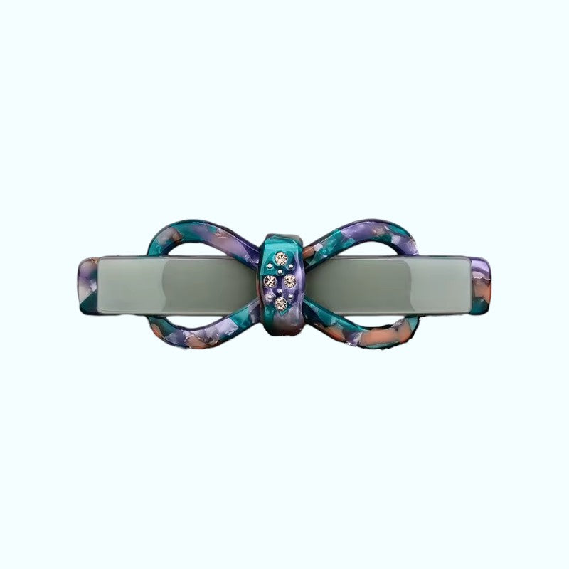 Multicolored hair clip with a decorative center on a white background