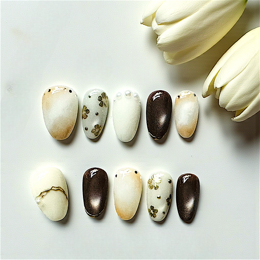 Set of decorative stones with floral patterns on a white surface with tulips.