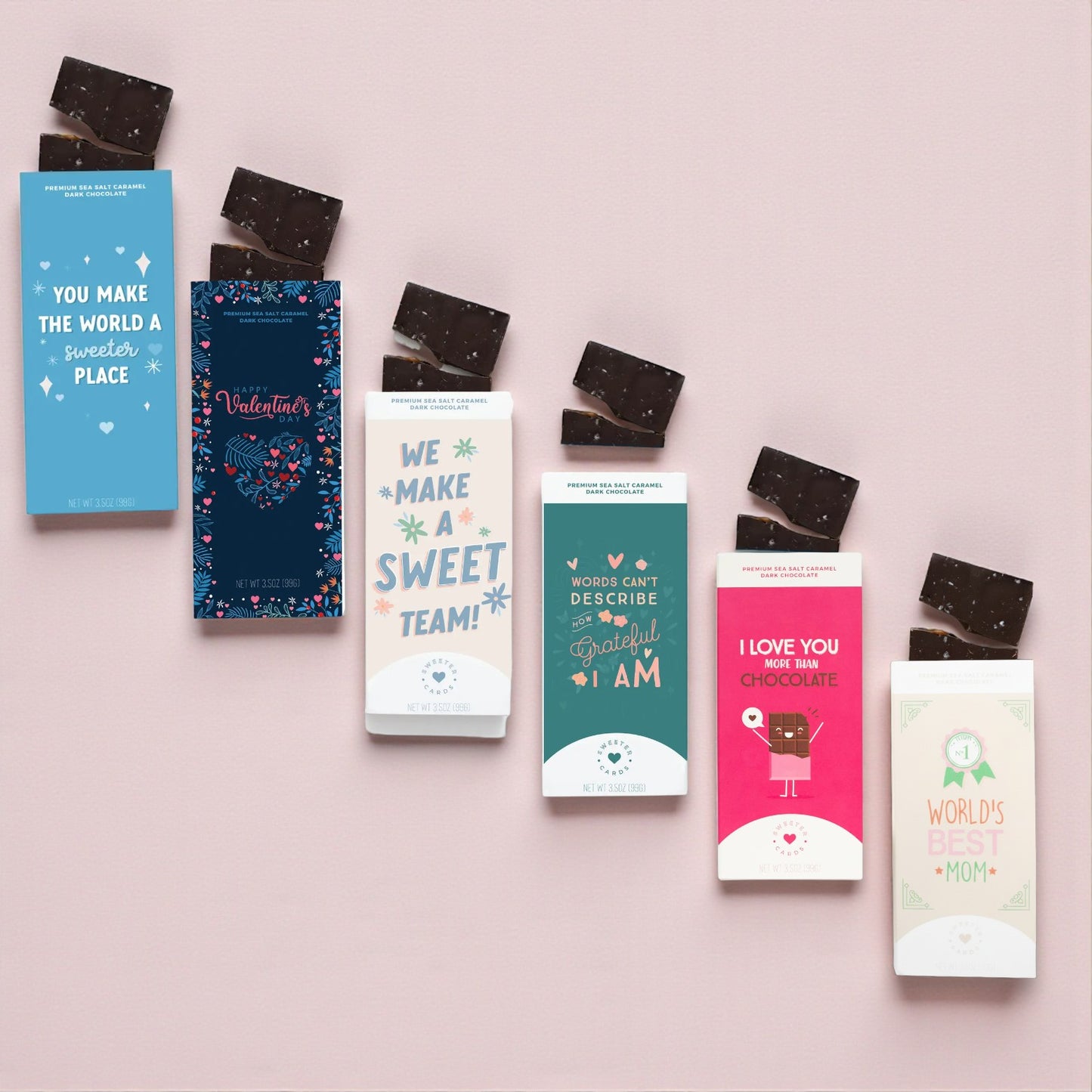 Assorted chocolate bars with colorful packaging on a pink background