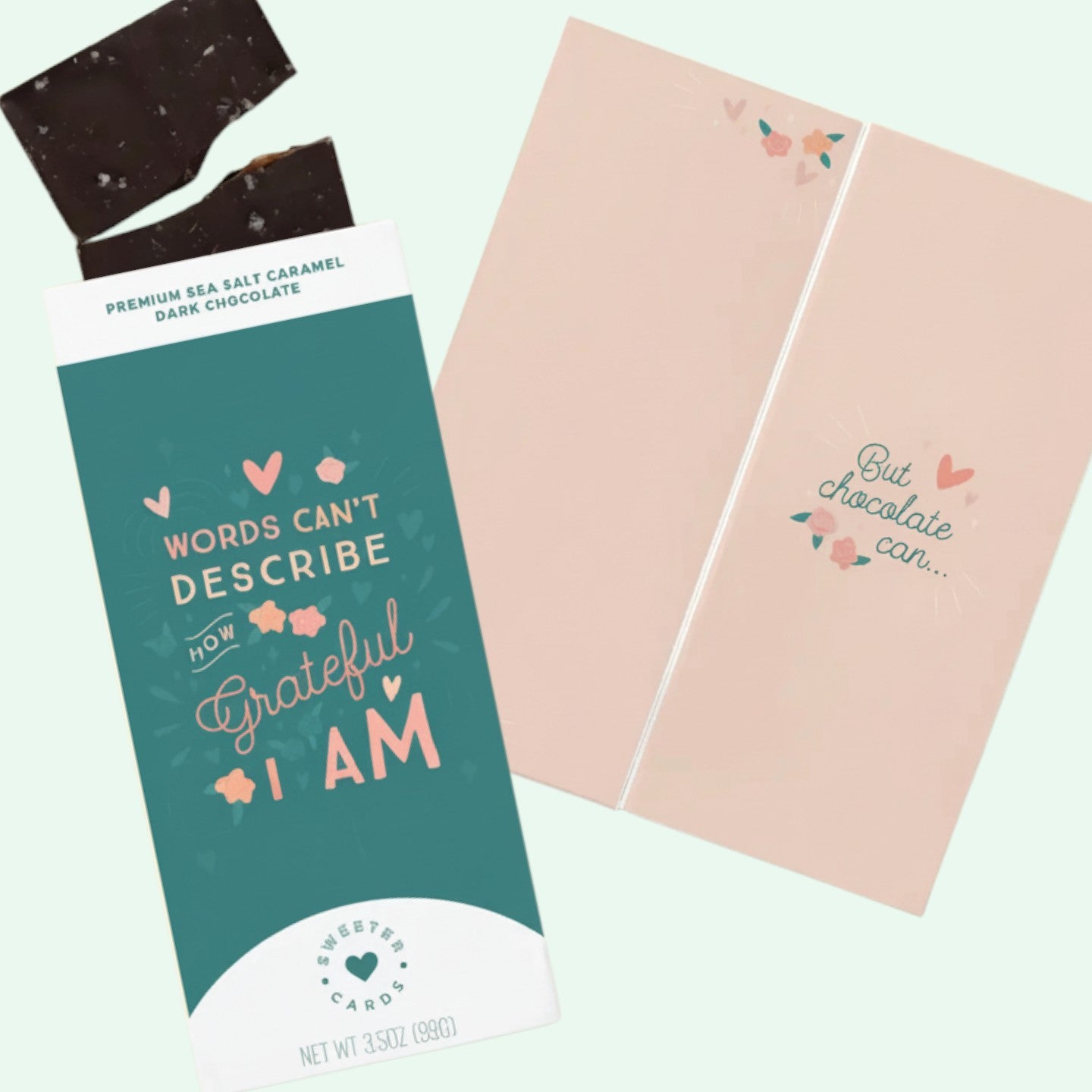 Chocolate bar with a message and a pink card on a light green background