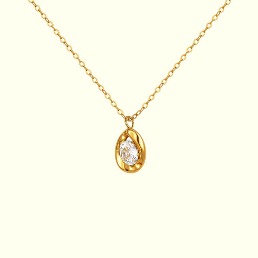 Gold necklace with a teardrop-shaped pendant on a white background