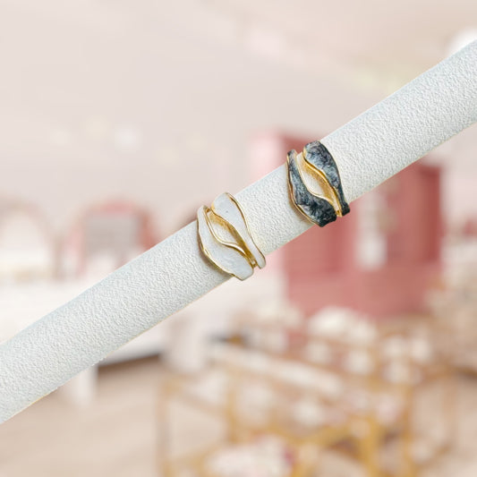 two rings on a cylinder with a blurry bows and knots co. store background