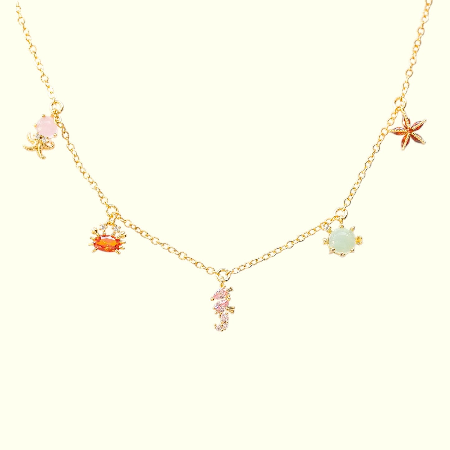 Necklace with various sea-themed charms on a white background