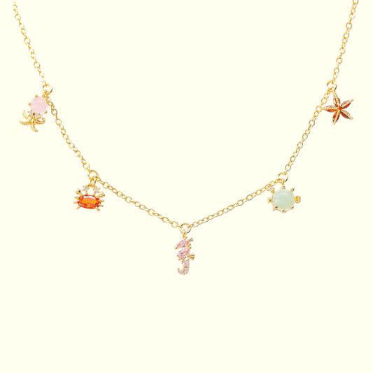 Necklace with various sea-themed charms on a white background