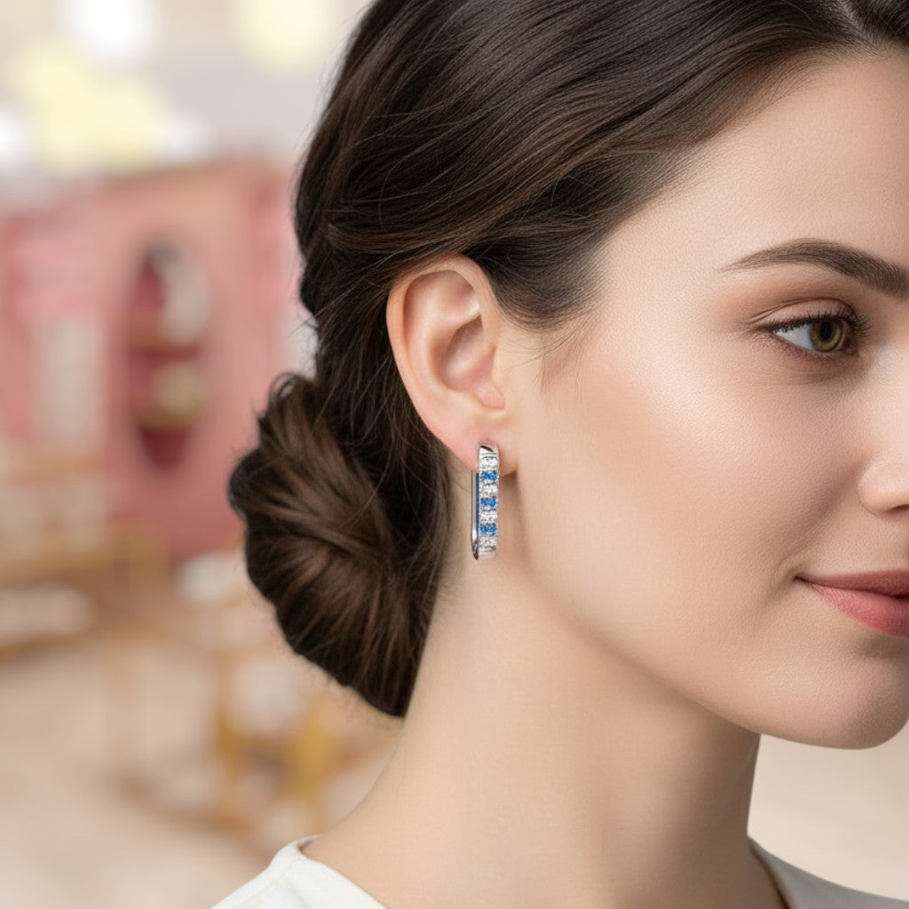 Close-up of a woman wearing a pair of hoop earrings with a blurred background