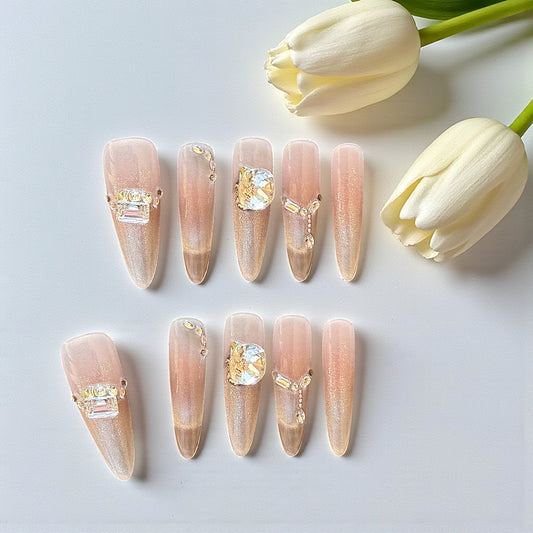 Nail art display with decorative nails and white tulips on a light background