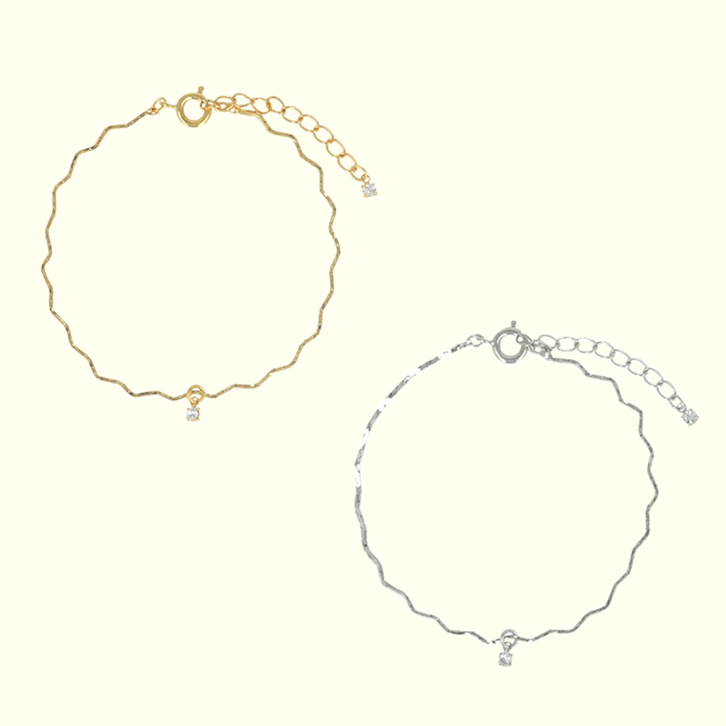 Gold and silver anklets on a white background
