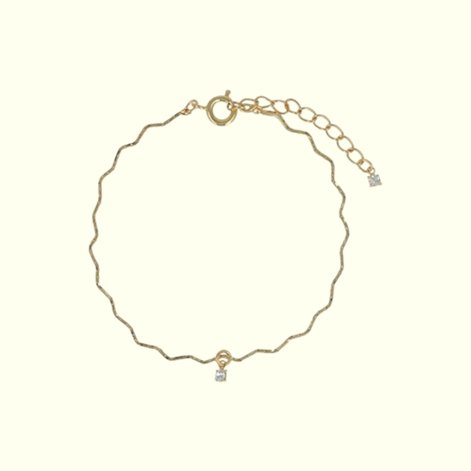 Gold bracelet with small diamond on a white background