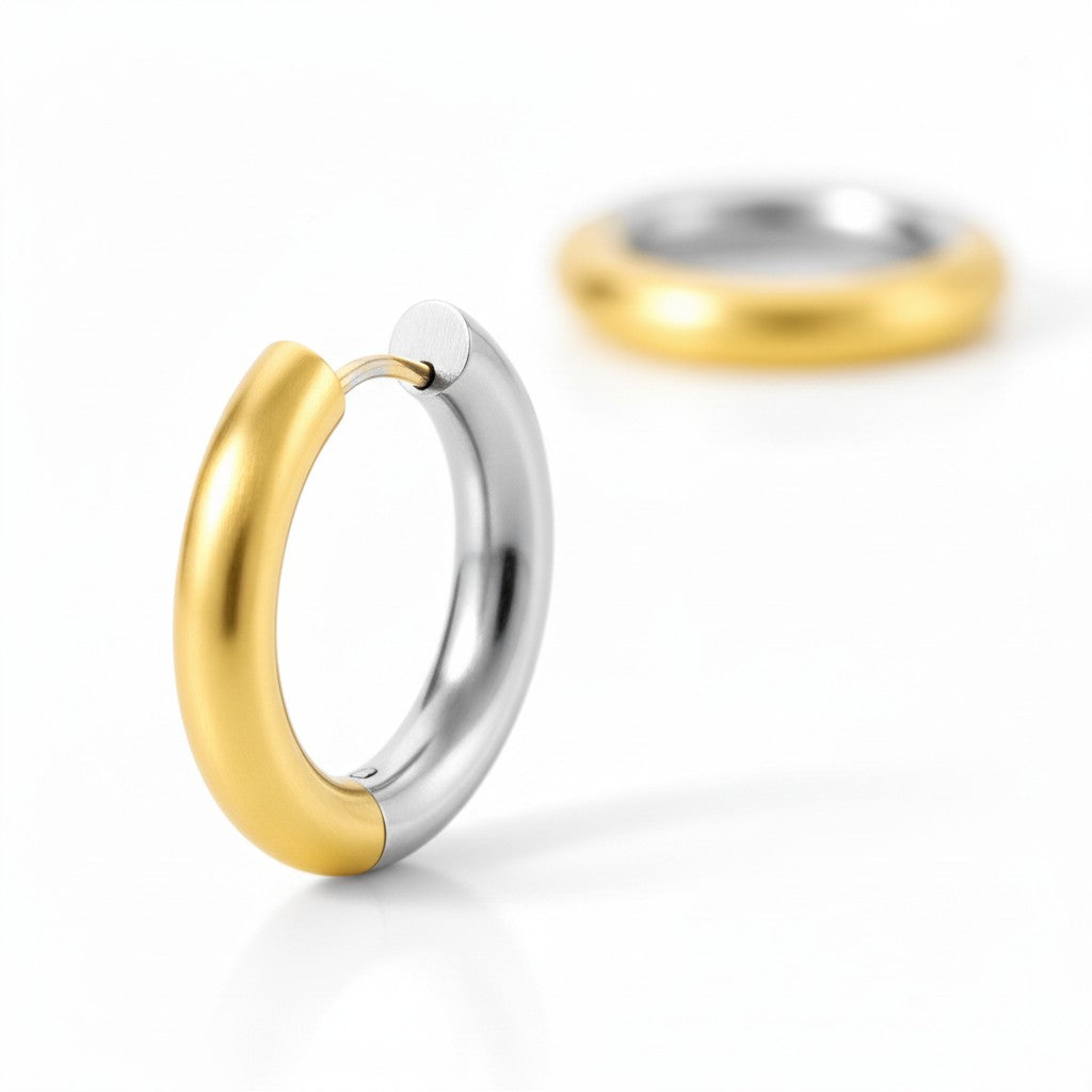 Gold and silver two-tone stainless steel hoop earrings with polished rounded design.