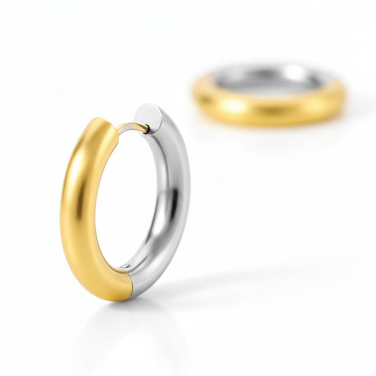 Gold and silver two-tone stainless steel hoop earrings with polished rounded design.