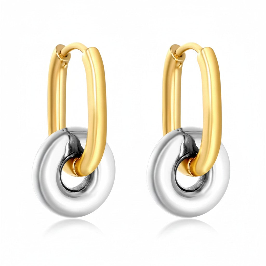 Gold and silver two-tone stainless steel hoop earrings with sculptural circular charms.
