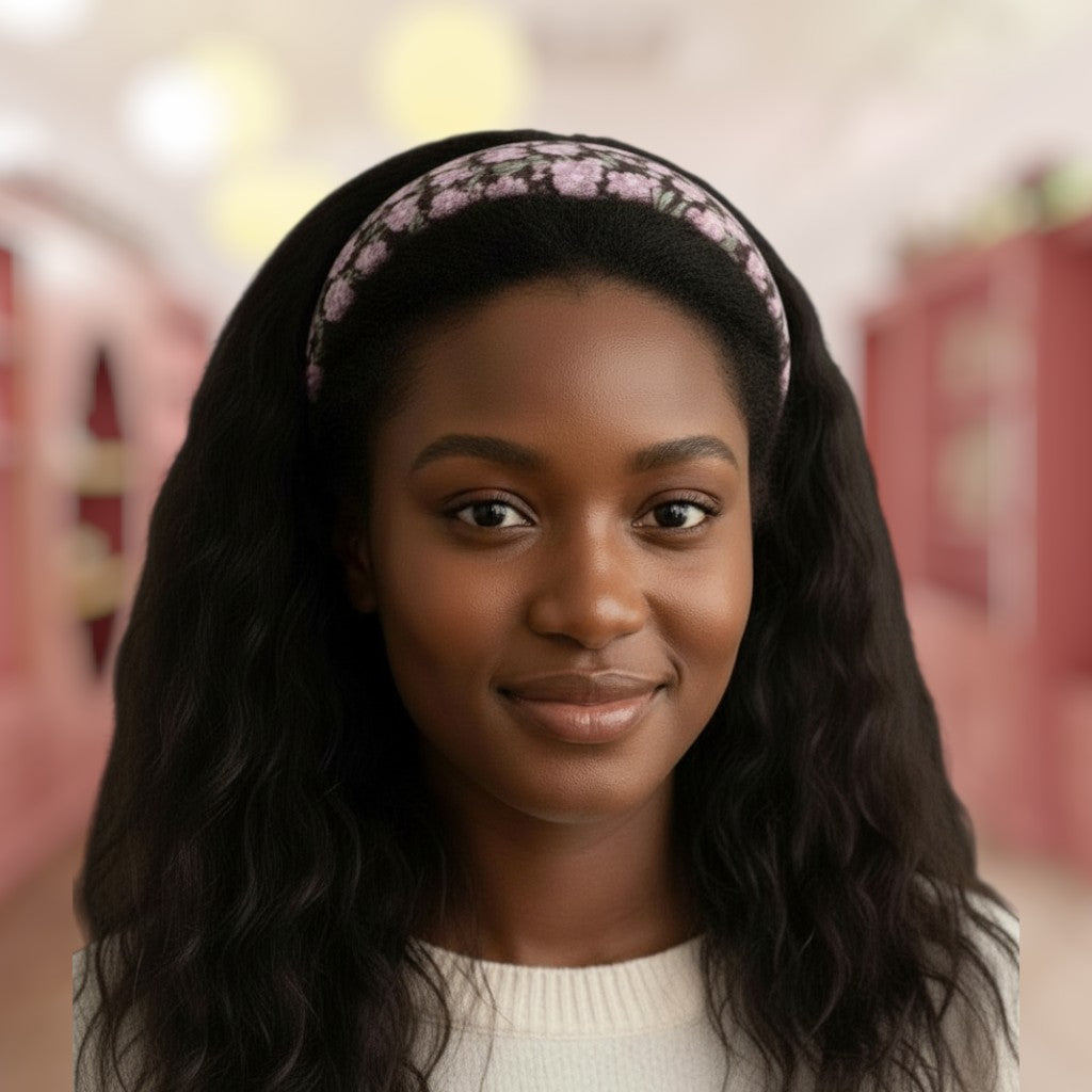 Woman with long dark hair wearing a floral headband in an indoor setting