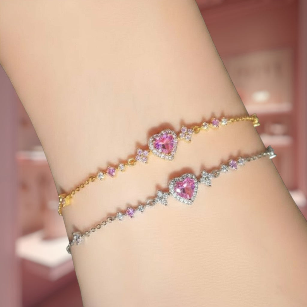 Two heart-shaped bracelet designs on a wrist with a blurred background