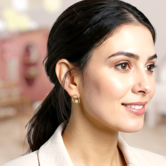 Woman wearing pearl earrings with a blurred background