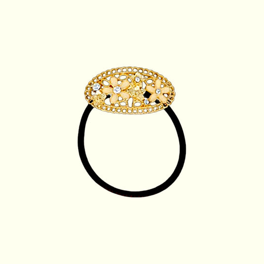 Decorative gold hair tie on a white background