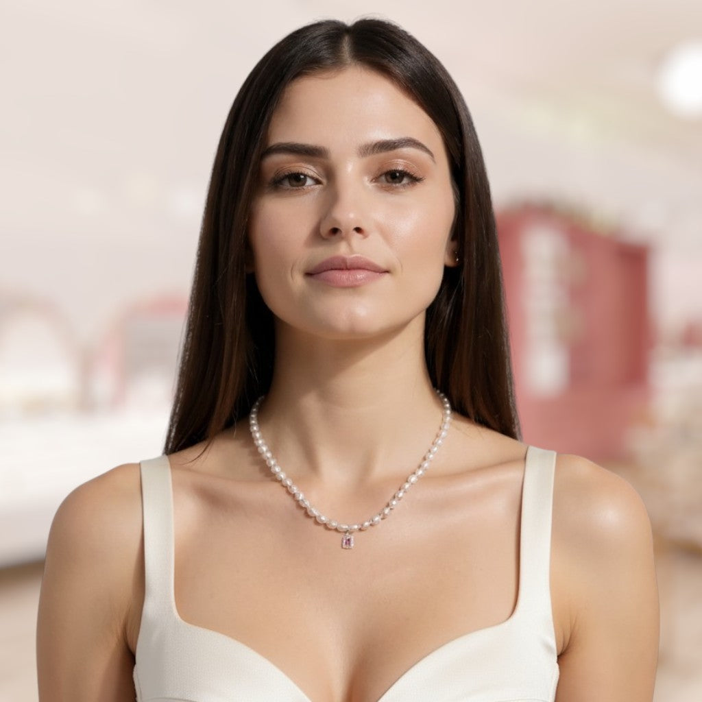 Woman wearing a pearl necklace with a blurred indoor background