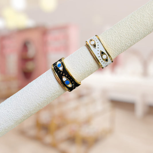 Two rings on a white cylindrical stand with a blurred background