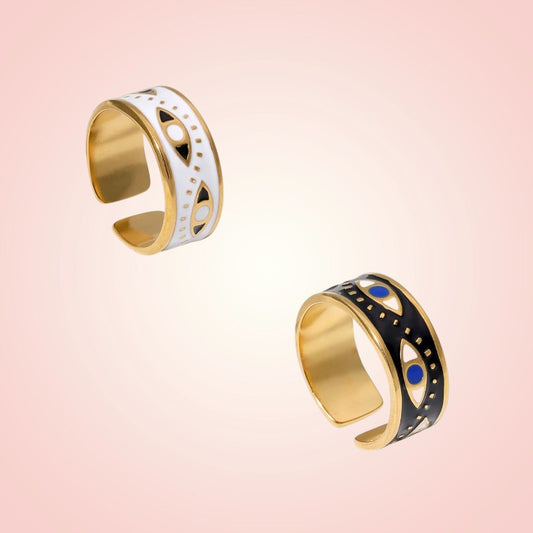 Two goldrings with geometric designs on a pink background