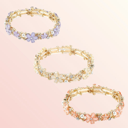 Three floral-themed bracelets on a pink background