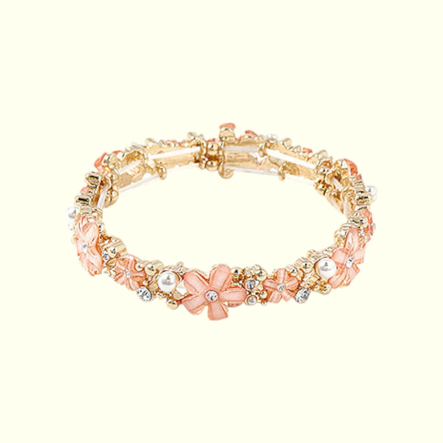 Gold and pink beaded bracelet on a white background
