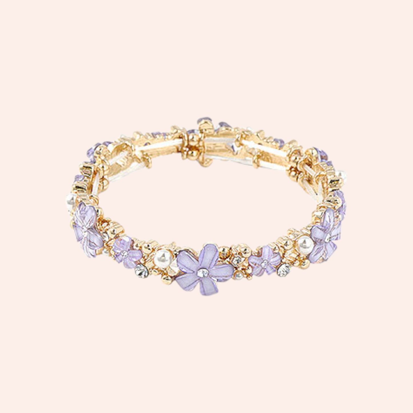 Gold bracelet with purple floral and pearl accents on a beige background