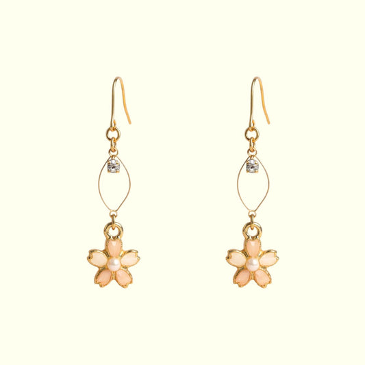 Pair of flower-shaped earrings with gold and pink details on a white background