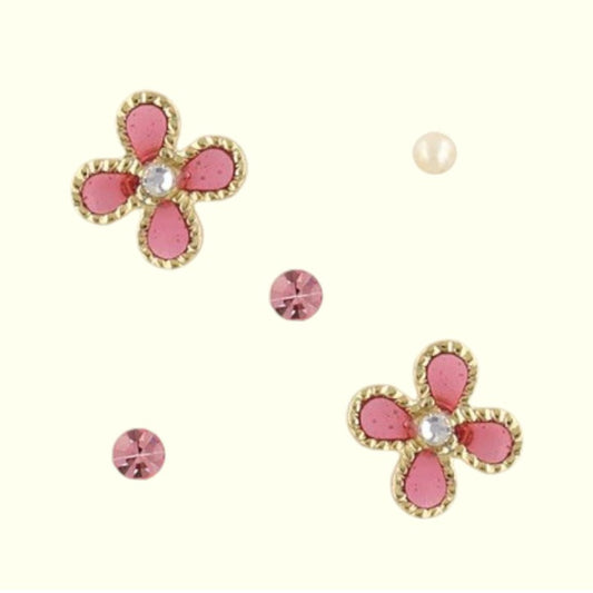 Set of pink flower-shaped earrings with gold accents on a white background