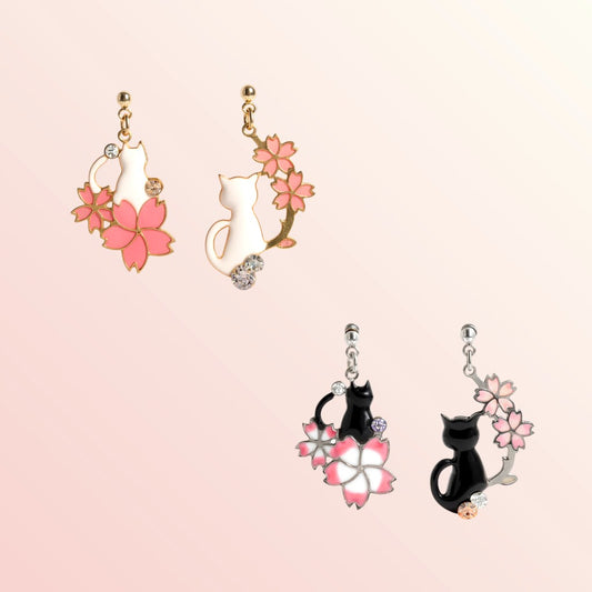 Cat-shaped earrings with floral designs on a pink background