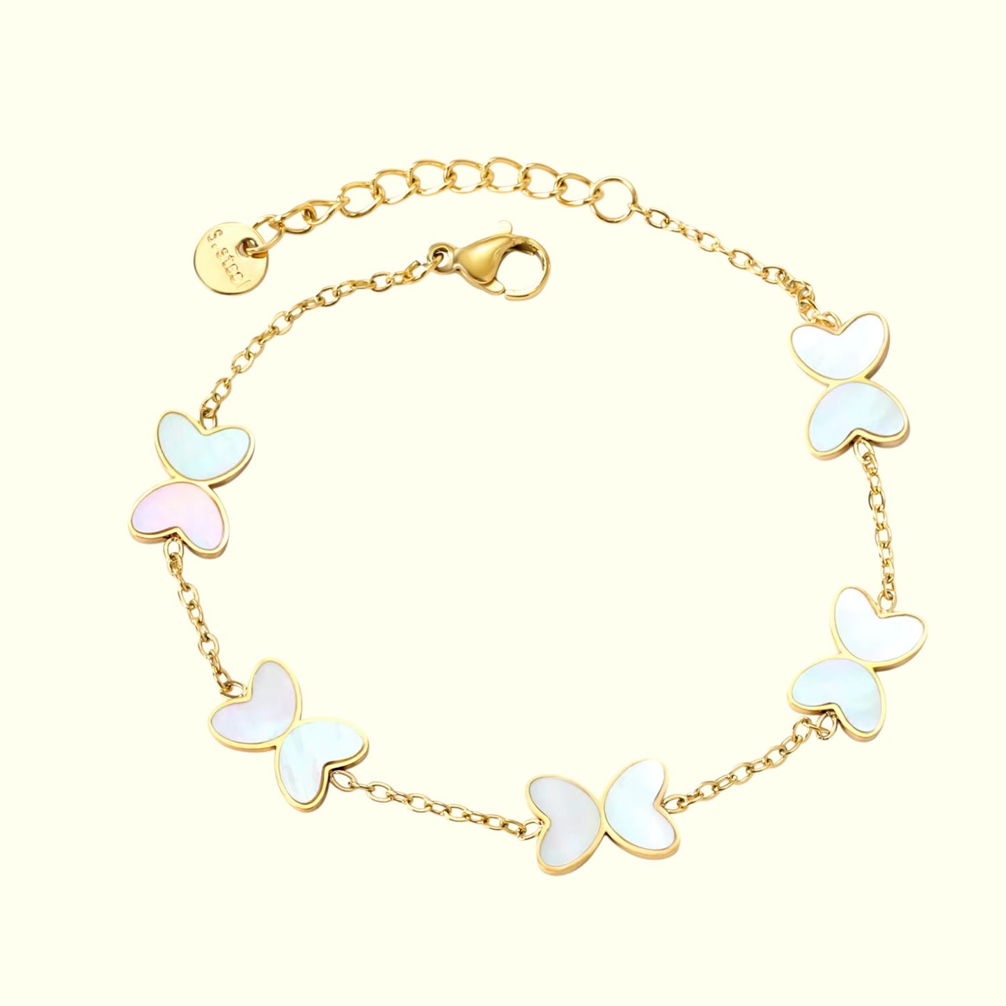 Gold bracelet with butterfly-shaped charms on a white background