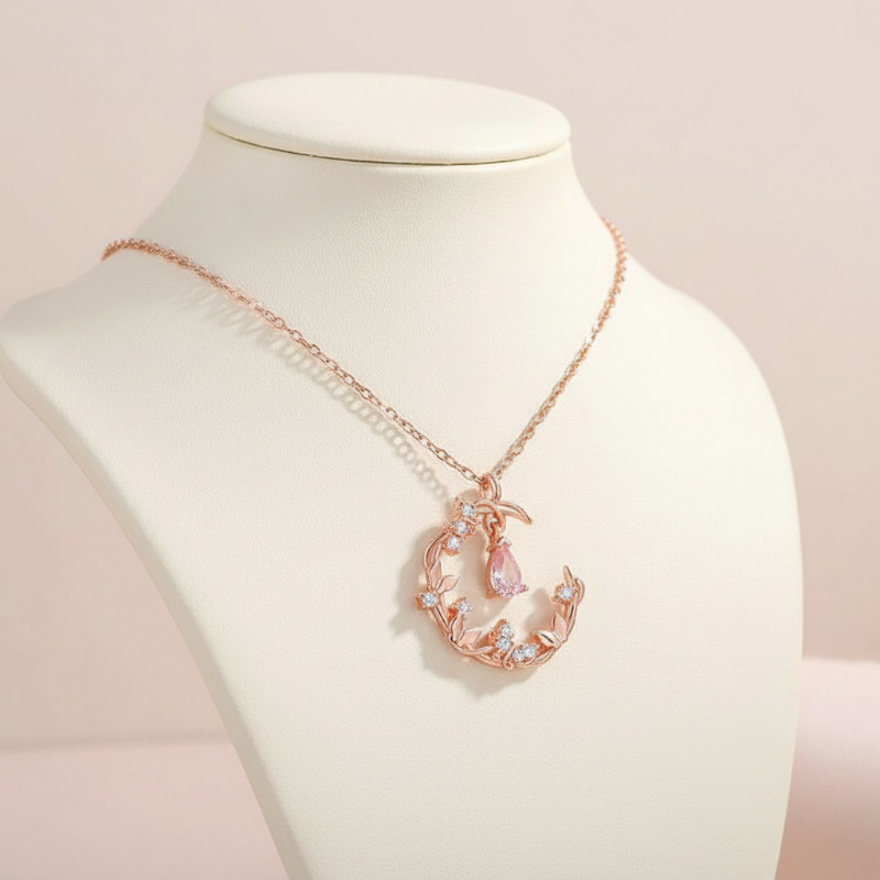 Rose gold necklace with a butterfly pendant on a mannequin bust.