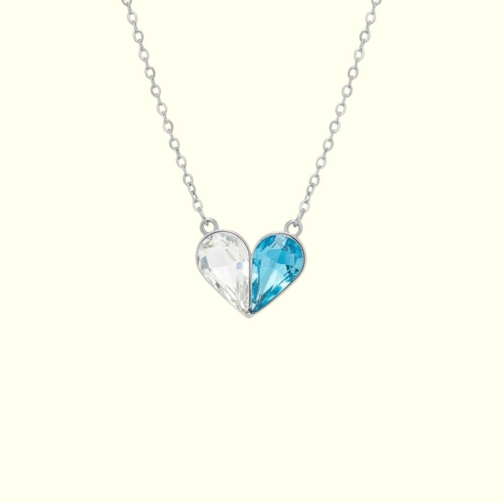 Necklace with a heart-shaped pendant featuring two colored stones on a white background