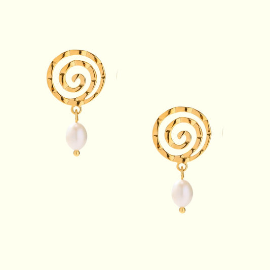 Gold spiral earrings with pearl drops on a white background