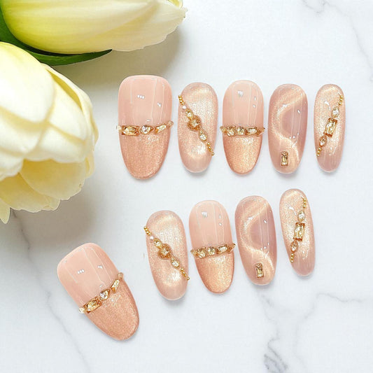 Nail art with gold accents on a white surface with yellow flowers.