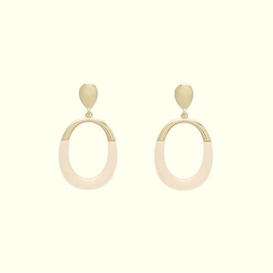 Pair of earrings with gold and beige hoop design on a white background