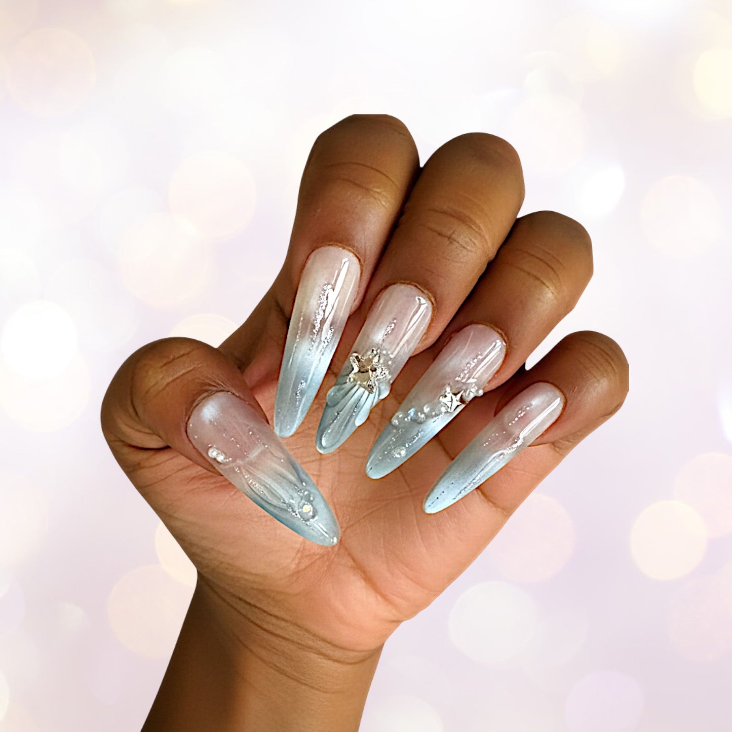 Hand with long, decorative nails on a blurred background