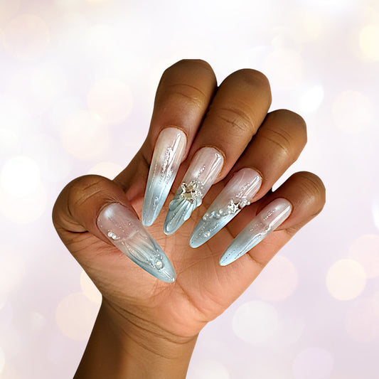 Hand with long, decorative nails on a blurred background