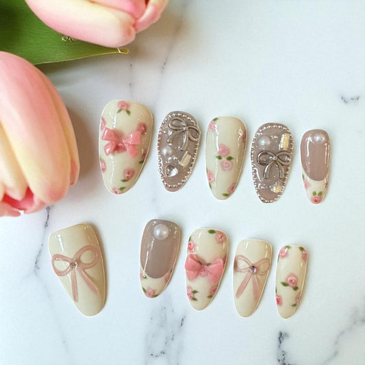 Set of decorative nail art designs on a marble surface with tulips.