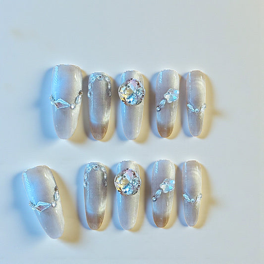 Decorative nails with crystals and rhinestones on a light background