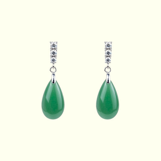 Pair of green teardrop earrings with silver and gemstone details on a white background