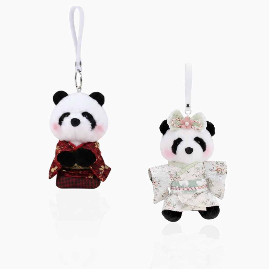 Two small plush panda charms wearing traditional-style outfits, each with a white hanging loop and metal clasp, shown on a clean white background.