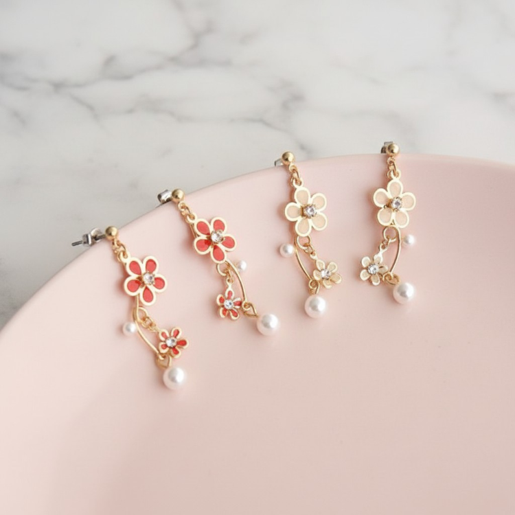 Floral earrings with pearl accents on a marble surface