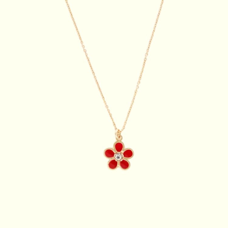 Gold necklace with a red flower pendant on a white background