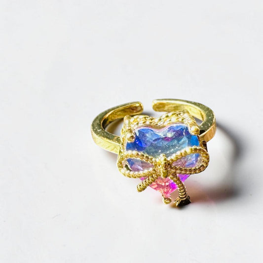 Gold ring with colorful gemstone on a white background