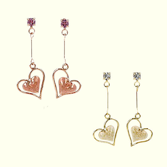 Pair of heart-shaped earrings in rose gold and gold on a white background