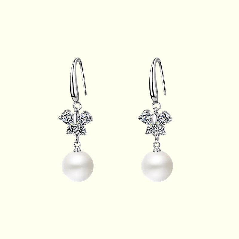 Pearl earrings with silver hooks on a white background