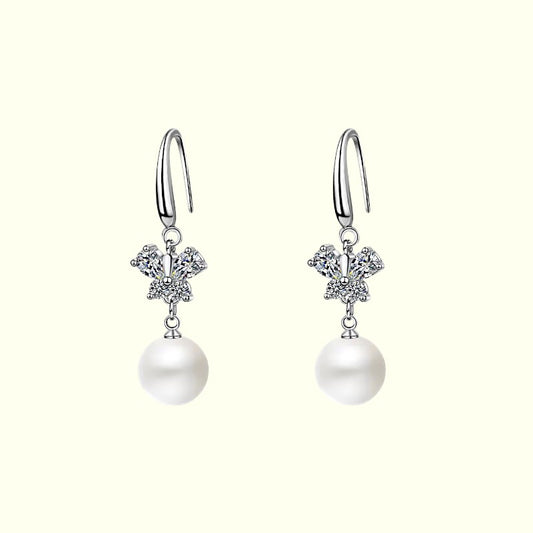 Pearl earrings with silver hooks on a white background